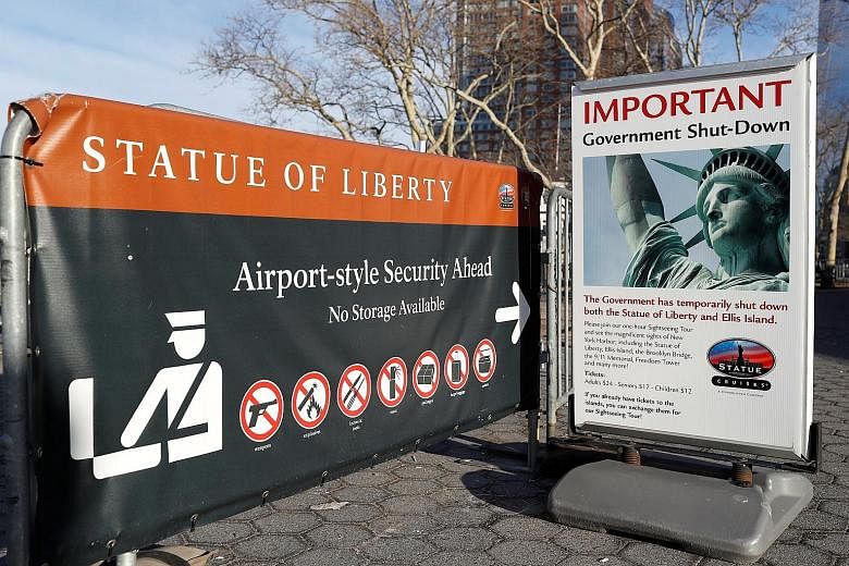 A sign near the ferry dock to the Statue of Liberty at Battery Park in Manhattan announcing the closure of the New York attraction as the government went into shutdown yesterday. Lawmakers were unable to pass a Continuing Resolution in time to avert 