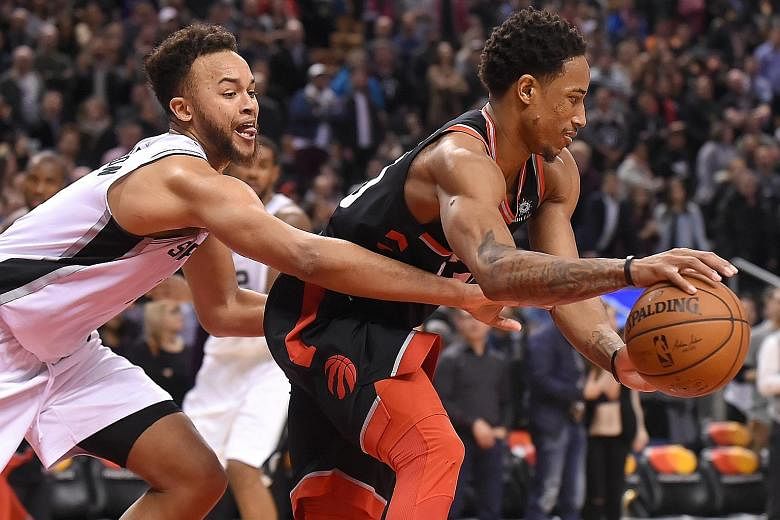 San Antonio guard Kyle Anderson tries to stop Toronto Raptors guard DeMar DeRozan at the Air Canada Centre on Friday. The hosts' solid defence proved key as they held on for a 86-83 win against the Spurs.