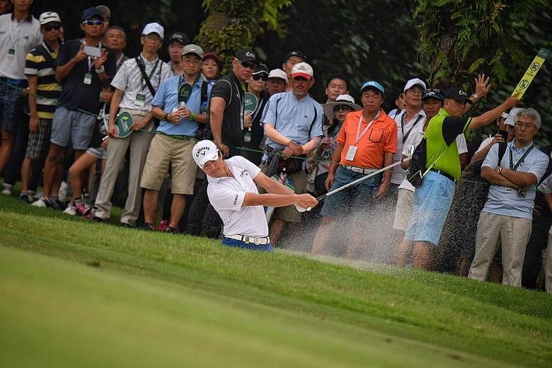 Japan's Ryo Ishikawa plays a bunker shot during the third round of the Singapore Open at Sentosa Golf Club's Serapong Course yesterday. Play was abandoned at 6.20pm due to lightning and will resume this morning.