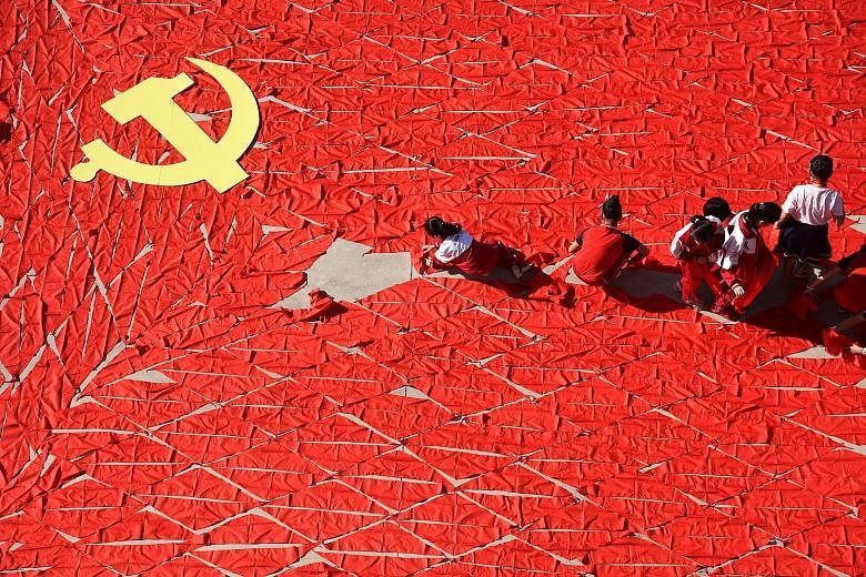 Students using red scarves to make a Chinese Communist Party flag in Linyi, Shandong province. The US document referred to China as "a strategic competitor using predatory economics to intimidate its neighbours".