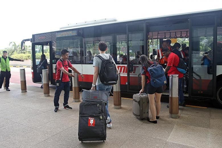 Travellers boarding a shuttle bus at Changi Airport Terminal 3 yesterday, when the Changi Airport MRT station was closed.
