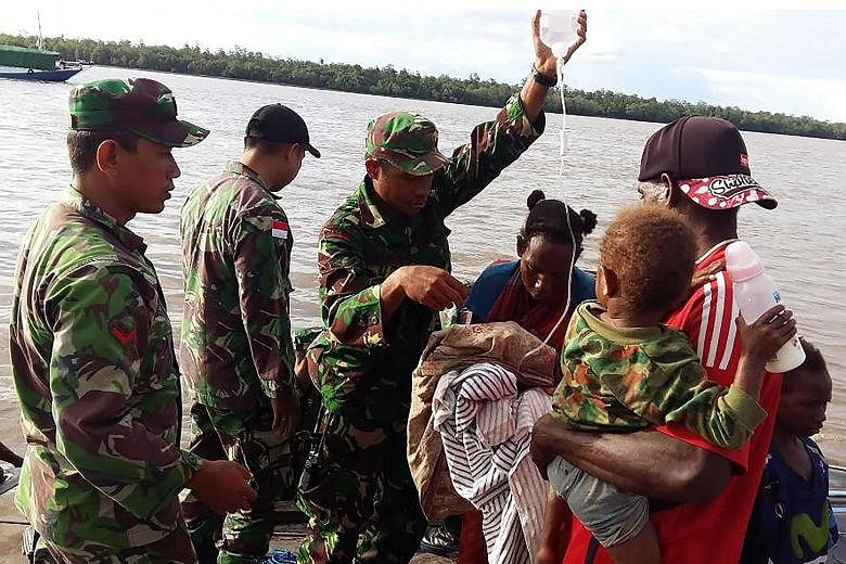 Indonesian military helping to transport children suffering from malnutrition in Asmat. The government and military have sent medical teams there and are supplying villagers with medicine, and food.
