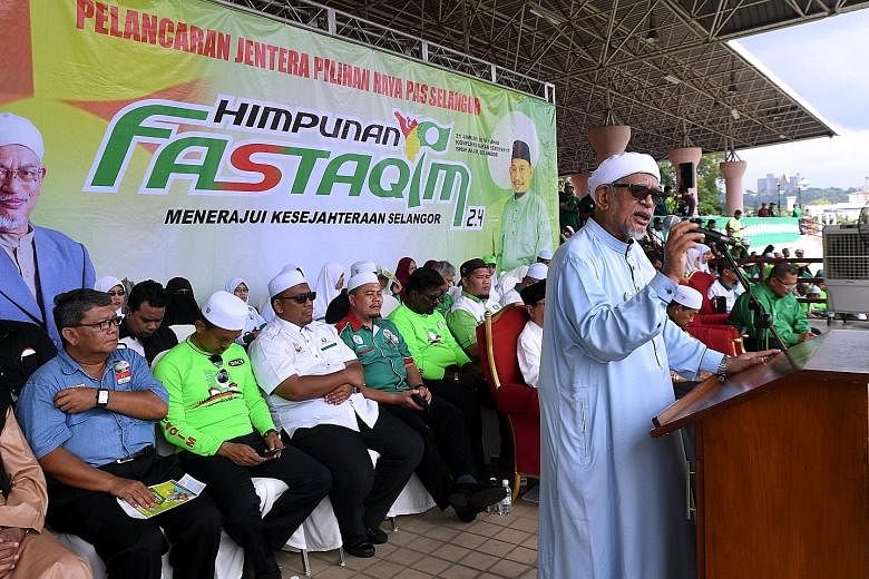 PAS president Abdul Hadi Awang speaking at a party function in Shah Alam yesterday. The Pakatan Harapan opposition alliance worries that PAS' decision not to work with it will cause multiple three-cornered fights that will benefit BN.