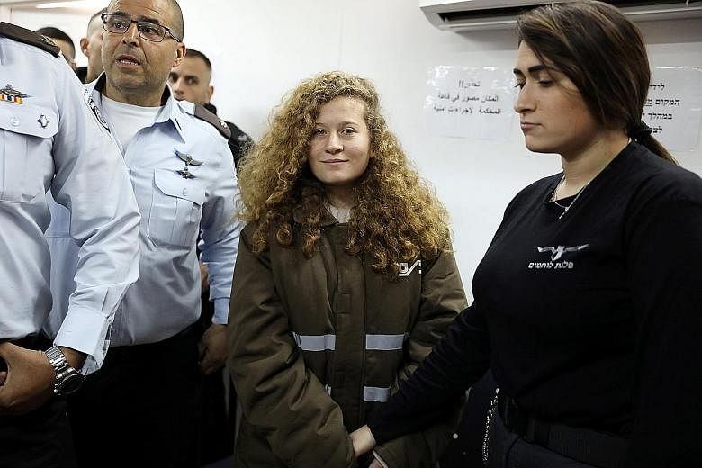 Ahed Tamimi being escorted into a military courtroom at Ofer Prison near Ramallah last week. She could face jail over an altercation in front of her house last month involving Israeli soldiers.