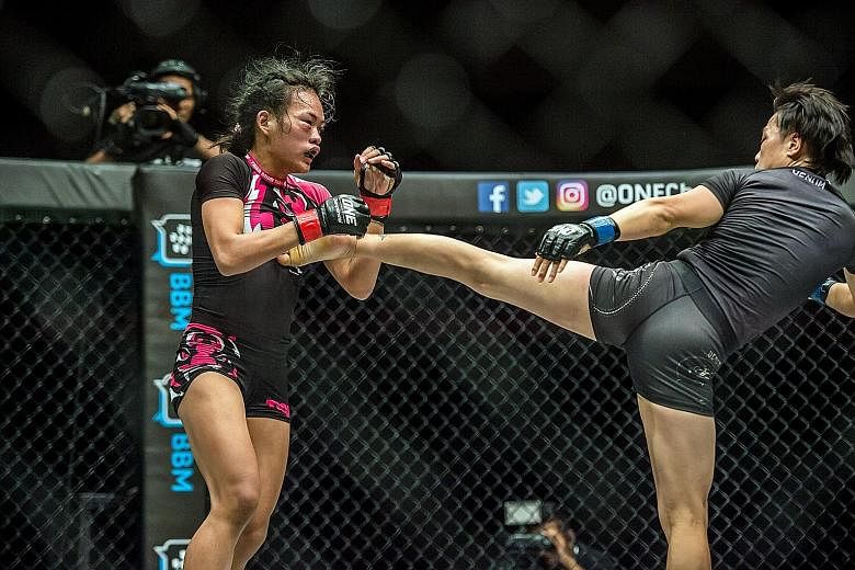 Xiong Jingnan landing a kick on Tiffany Teo's chest during their One Championship strawweight fight in Jakarta. The Chinese won on a TKO by referee stoppage.