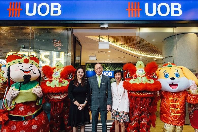UOB deputy chairman and chief executive Wee Ee Cheong, flanked by Ms Jacquelyn Tan (left), head of personal financial services Singapore, and Ms Janet Young, head of group channels and digitalisation, at the opening of the bank's new branch in Tampin