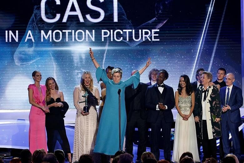 Actresses Brie Larson (far left) and Lupita Nyong'o presenting the award for outstanding performance by a cast in a motion picture during the 24th Annual Screen Actors Guild Awards show. Frances McDormand, arms outstretched, celebrates with the cast 