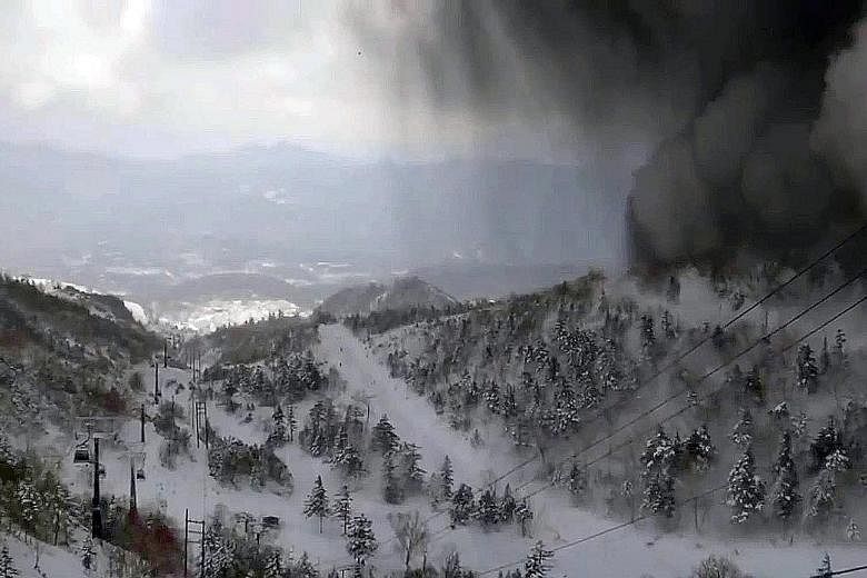 An image taken from the Kusatsu-Shirane gondola camera yesterday shows thick black smoke sliding down the snow-covered side of the volcano towards a ski slope after an eruption. Japanese media reported that many of the injured were apparently hit by 