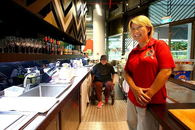 Ms Geraldine Tan, CEO of social enterprise My NoNNa's, with chef Jasmine Ho (in black), who works in My NoNNa's Wheelchair Workplace Friendly Cafe at SUTD. The cafe was designed by Ms Tan and seven SUTD students as part of their final-year project.