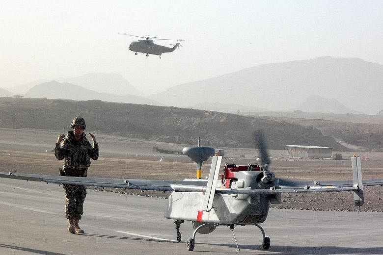 A Searcher UAV being prepared for take-off in Afghanistan. The RSAF's UAV team, which was deployed in the war zone from August to November 2010, was tasked with providing surveillance and reconnaissance for international forces there.