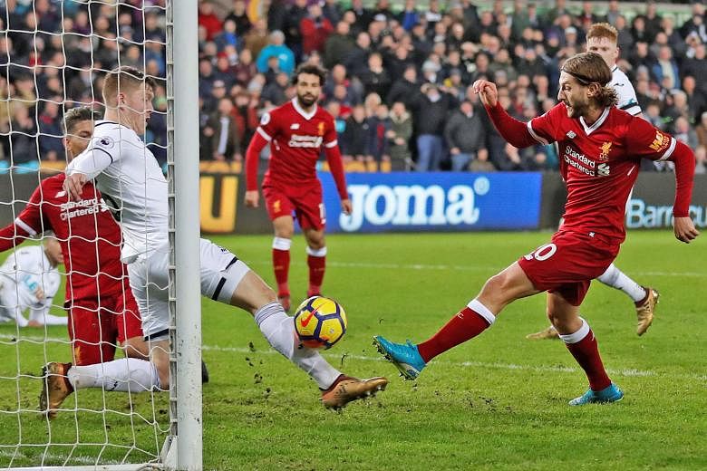 Liverpool's Adam Lallana (far right) misses a chance to equalise deep into stoppage time as Alfie Mawson blocks his shot. The 1-0 defeat by Swansea on Monday was only the Reds' third league loss this season and came after beating EPL leaders Manchest