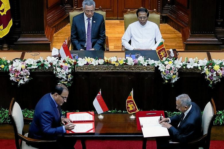 Dr Saman Kelegama, Sri Lanka's chief negotiator, died of a heart attack last June, casting a cloud of uncertainty over the future of the FTA negotiations. Singapore's Minister for Trade and Industry (Industry) S. Iswaran (far left) signs the bilatera