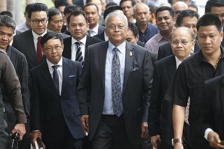 Suthep Thaugsuban and members of his political activist group arriving at the Criminal Court in Bangkok yesterday.