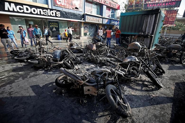 Burnt motorbikes outside a multiplex in Ahmedabad yesterday. Protesters went on the rampage in the Gujarat city ahead of the planned release of Bollywood movie Padmaavat today.