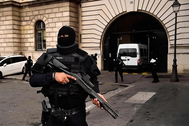 French police standing guard as a van carrying Bendaoud arrives at a courthouse in Paris yesterday.