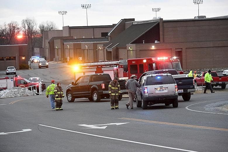 Police investigators at the scene of the shooting at Marshall County High School. The 15-year-old suspect killed two people and injured 12 other students before a sheriff's deputy managed to stop and apprehend the boy who was armed with a handgun.