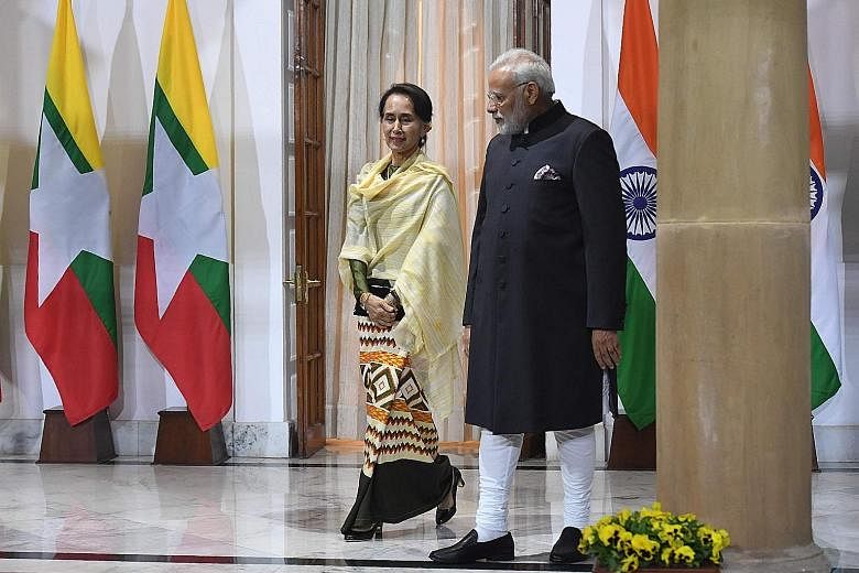 Indian Prime Minister Narendra Modi welcoming Myanmar's civilian leader, Ms Aung San Suu Kyi, yesterday, ahead of a meeting on the sidelines of the Asean-India Commemorative Summit in New Delhi.