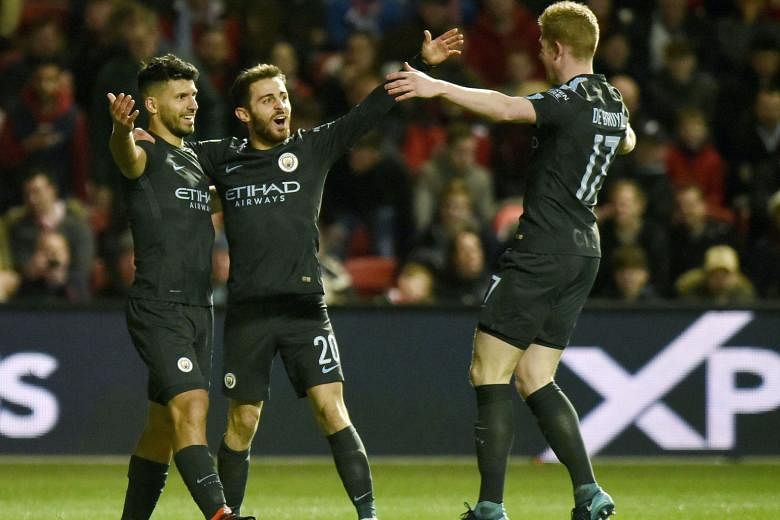 Manchester City's Sergio Aguero (left) celebrating his goal against Bristol City during their League Cup semi-final second leg with Bernardo Silva and the architect of the move, Kevin de Bruyne. City won 5-3 on aggregate.