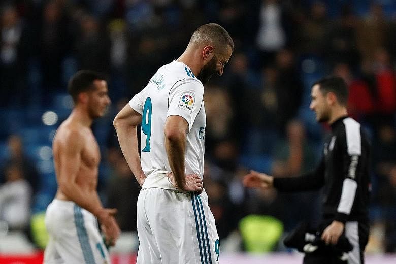 Real Madrid's Karim Benzema wincing in agony after his side were dumped out of the King's Cup by Leganes, who had never won at the Bernabeu prior to their quarter-final, second-leg tie. Valencia aim to compound their misery in the league tomorrow.