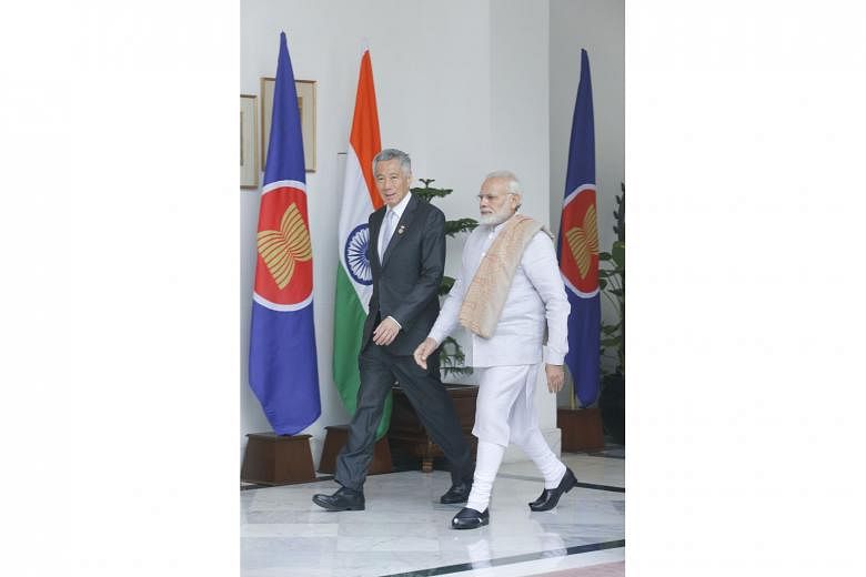 Prime Minister Lee Hsien Loong and his Indian counterpart, Mr Narendra Modi, on their way to a meeting in New Delhi yesterday. As Asean chair, Singapore is committed to deepening Asean-India ties, says PM Lee.