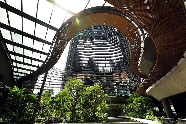 A key design feature of Marina One is the curved levels that look like rice terraces in Asia. Nestled at the bottom of the four tall buildings of Marina One (above) is a lush wooded landscape resembling a green valley.