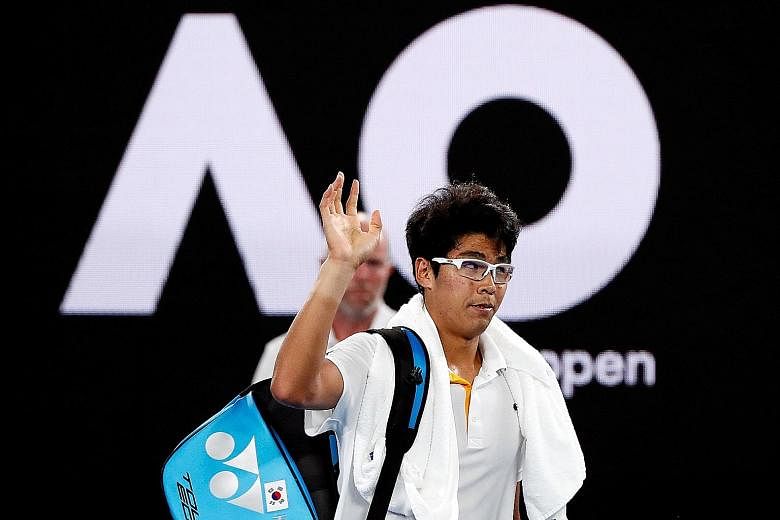 Chung Hyeon leaving the Rod Laver Arena in Melbourne yesterday after retiring injured against Swiss legend Roger Federer in the semi-finals.