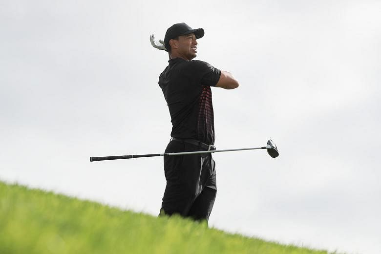 From top: A theatrical Tiger Woods dropping his club in disgust and groaning loudly at the 12th tee, but the TV cameras cut back to a chuckling Woods, when the ball travelled 316 yards and found the middle of the fairway. The former world No. 1 looki