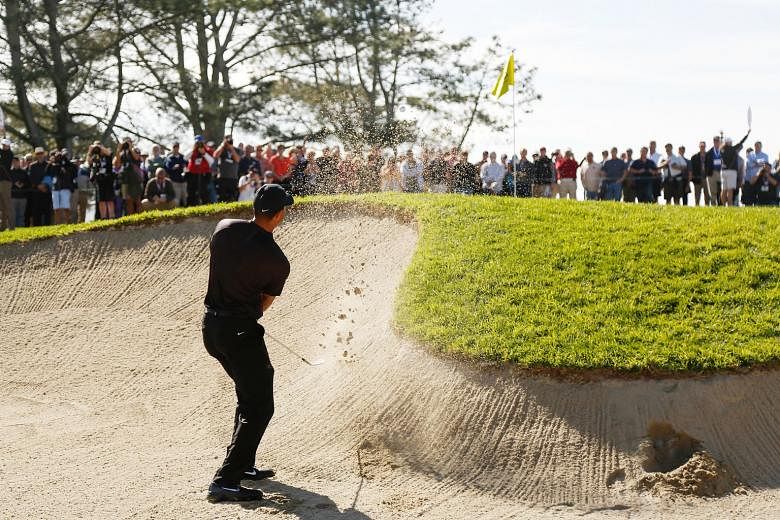The 14-time Major champion playing a shot from a bunker on the first hole, where he failed to hit the fairway and green and ended up with a bogey five.