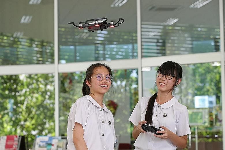 Chong Zhi Yu (left), 16, and Koh Si Siang, 12, work with a micro:bit. Learning to program the tiny computers is a new part in the school's iSCoRe2 curriculum. A student experimenting with virtual reality technology at Anglican High's iCrea+e corner i