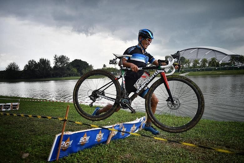 Men's elite cyclocross winner Makoto Shimamoto jumping over an obstacle during his second-last lap at the fourth Annual Singapore/Asia Cyclocross. The Kallang Riverside Park was transformed into a cyclocross race course yesterday for 100 cyclists, wh