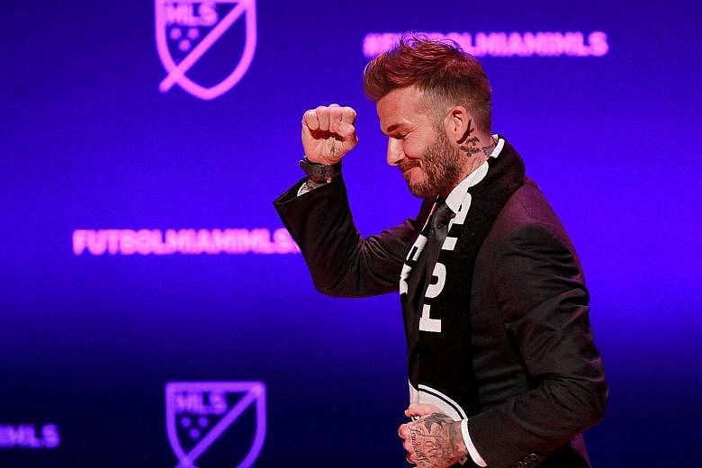 David Beckham salutes the crowd at the launch of his Major League Soccer team in Miami, after four years of wrangling over a stadium site.