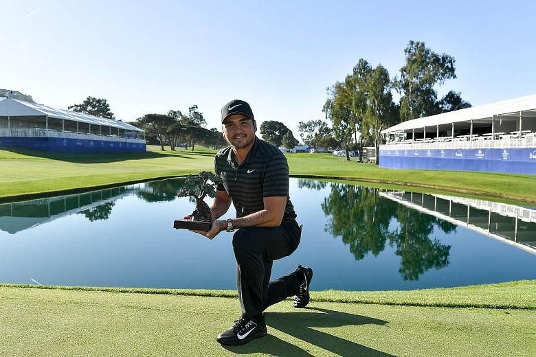 Australian Jason Day with his trophy on Monday, after taking six extra holes to overcome Swede Alex Noren in the Farmers Insurance Open at Torrey Pines South near San Diego.