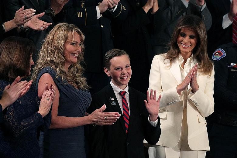 First Lady Melania Trump (at right) with Preston Sharp, 12, who was honoured for his efforts to decorate war veterans' graves at the State of the Union address in the Chamber of the US House of Representatives.