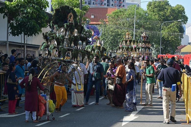 Devotees taking part in the Thaipusam festival yesterday. Many walked barefoot carrying milk pots and some carried kavadis from Sri Srinivasa Perumal Temple in Serangoon Road to Sri Thendayuthapani Temple in Tank Road.