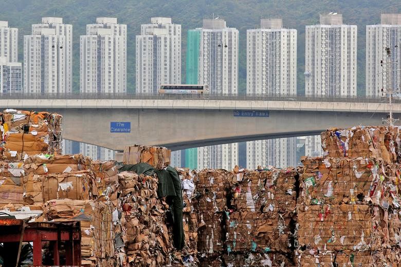 Mountains of old newspapers, cardboard and office scrap have piled up in Hong Kong's docks over the past few months, while plastic waste has been dumped into the landfills.