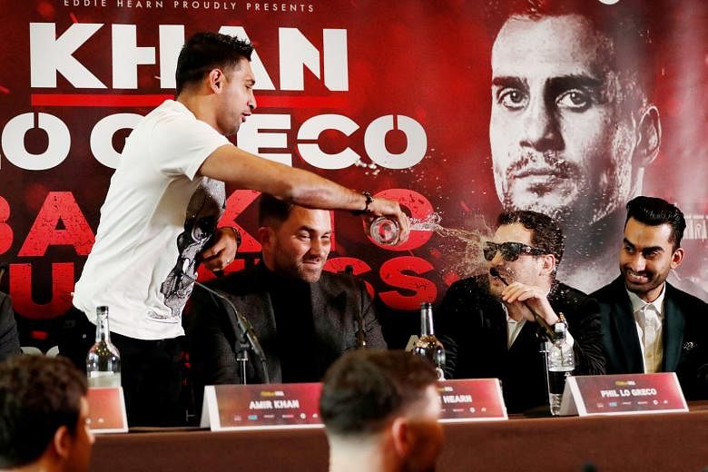 Amir Khan throwing water on Phil Lo Greco during the press conference on Tuesday. After security personnel stepped in, the Briton insisted that he would train for their bout in Liverpool on April 21 as though it were a world title fight.
