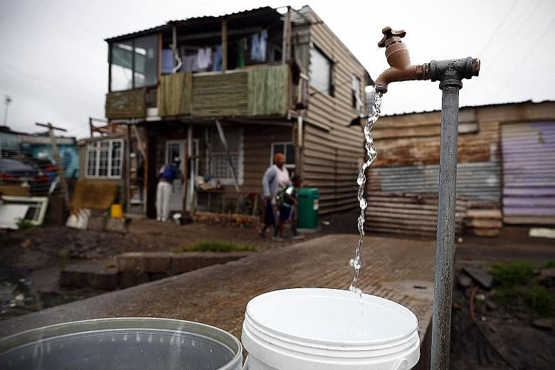 Drinking water being collected from a communal tap in Masiphumelele township, Cape Town, on Tuesday.