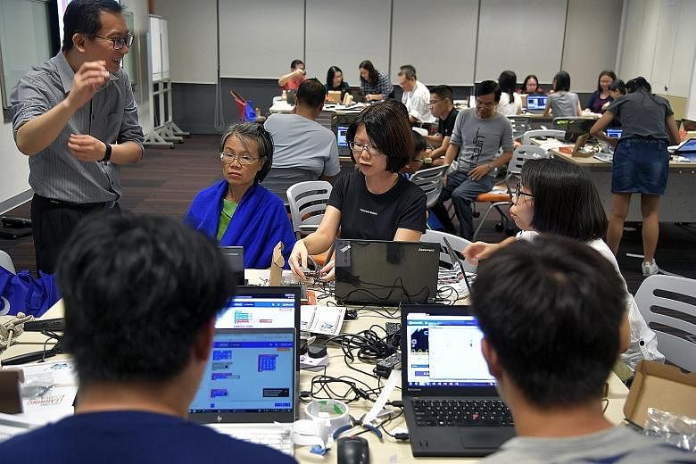 Participants attending a robotics workshop last October at the Lifelong Learning Festival, where the SkillsFuture Series was launched. The most popular course category among those using their SkillsFuture Credit last year was infocomm technology.