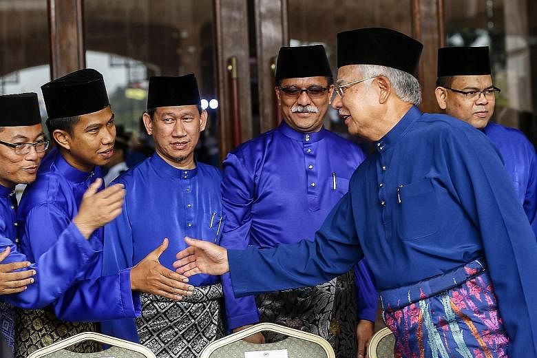 Malaysian Prime Minister Najib Razak (right, front) shaking hands with attendees of the Special Haj Sponsorship Programme event at Putra Mosque in Putrajaya yesterday.