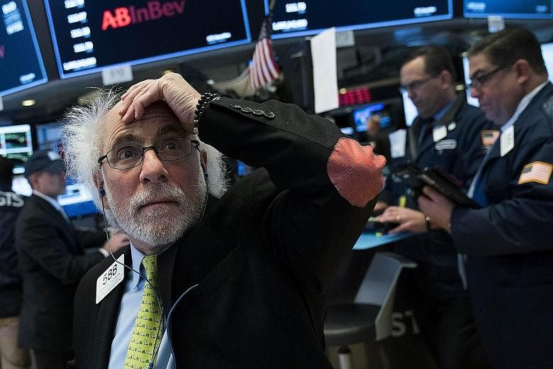 A trader at the New York Stock Exchange reacting to the closing bell last Friday, which saw US stocks diving after a stronger-than-expected job report.