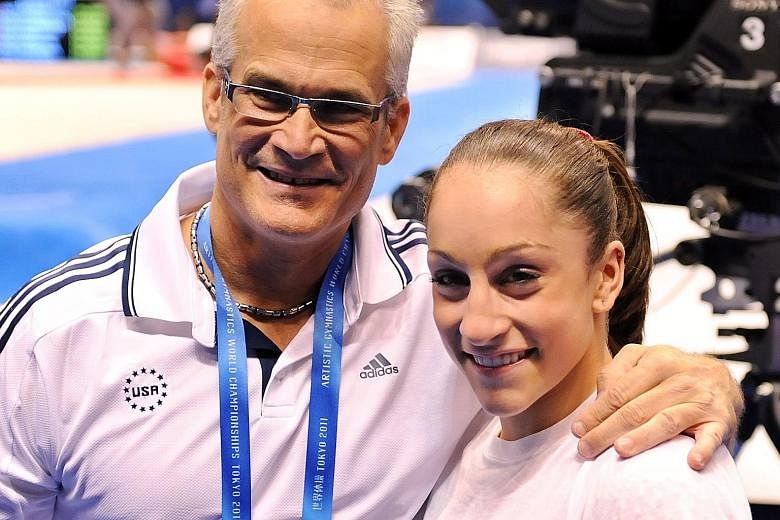 United States gymnast Jordyn Wieber with her coach, John Geddert, in the women's all-around final at the World Gymnastics Championships in Tokyo in 2011. Geddert, 60, is under probe because of his close ties to Larry Nassar, the former US national te