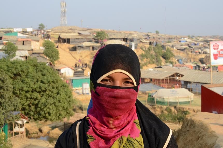 The hills in southern Cox's Bazar have been stripped of foliage and packed instead with thousands of bamboo-framed, tarpaulin-lined huts. Left: Ms Khursida Begum, 20, a Rohingya refugee with two children. She is one of the female volunteers engaged b