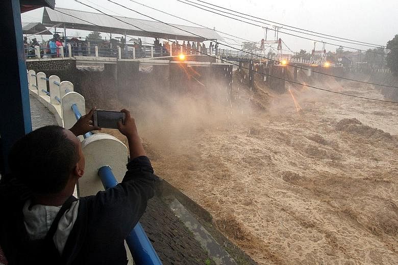 Water gushing through after sluice gates at a reservoir in Bogor, West Java, were opened yesterday. The authorities were forced to open the gates after heavy rain caused floods and landslides in cities surrounding Jakarta.