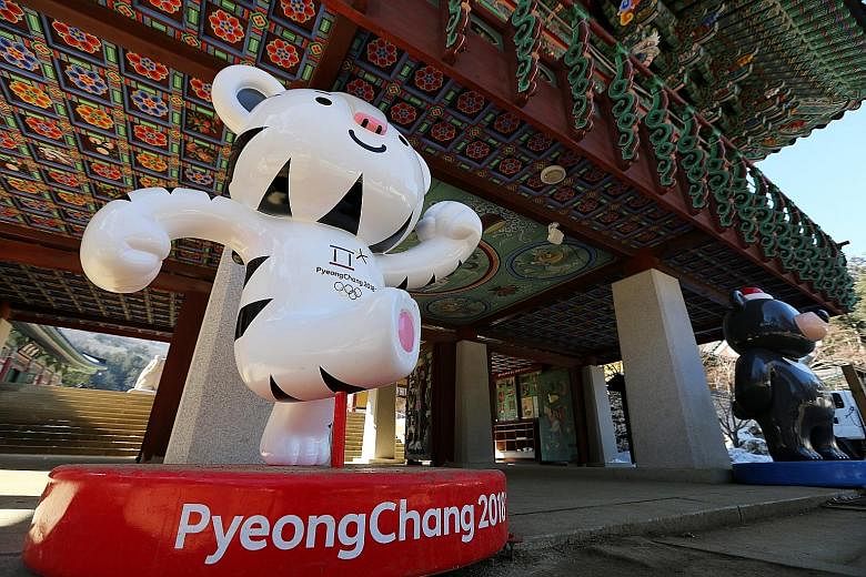 Mascots Soohorang (left) and Bandabi at the entrance of the Woljeongsa Temple in Pyeongchang. The Winter Olympics start on Friday but the International Olympic Committee has barred 15 Russians from competing.