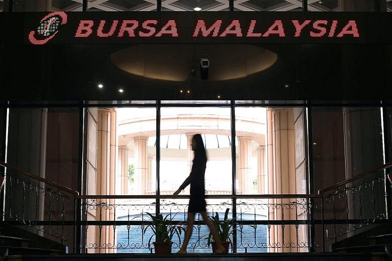 The Monetary Authority of Singapore and Securities Commission Malaysia will set up cross-border supervisory and enforcement arrangements, and work with the Singapore Exchange (left) and Bursa Malaysia to operationalise the stock market link, which wi