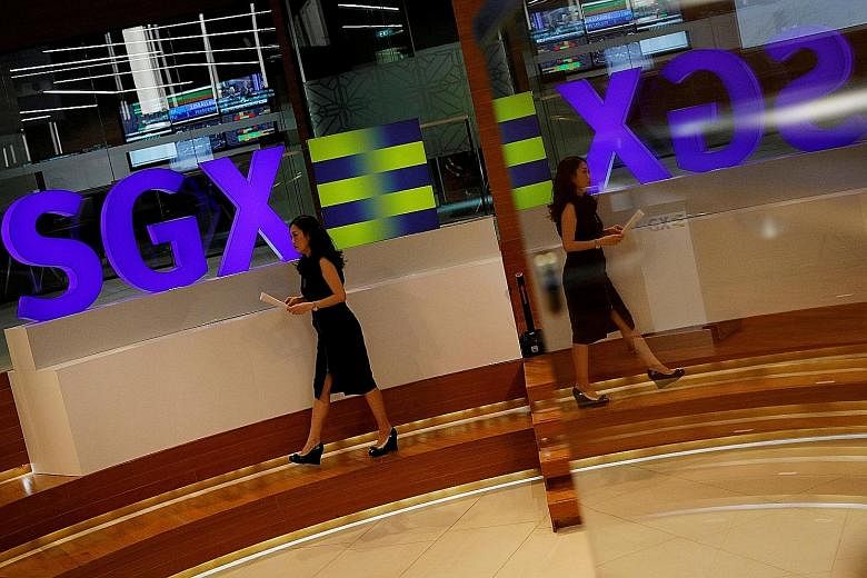 The Monetary Authority of Singapore and Securities Commission Malaysia will set up cross-border supervisory and enforcement arrangements, and work with the Singapore Exchange (left) and Bursa Malaysia to operationalise the stock market link, which wi
