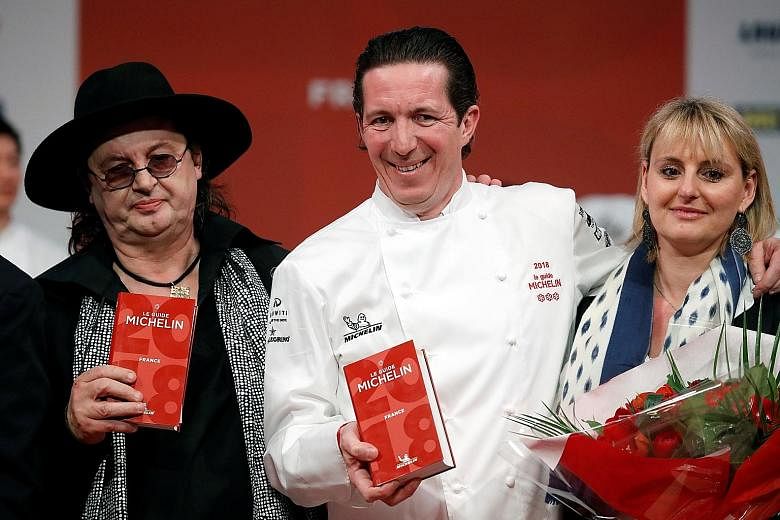 (From far left) Marc Veyrat, with fellow French chef Christophe Bacquie and his wife, Ms Alexandra Perbet, at an award ceremony at the Seine Musicale centre near Paris on Monday.