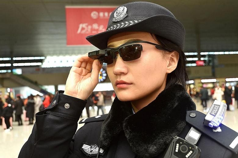A police officer wearing a pair of smartglasses with a facial recognition system at a railway station in Zhengzhou, China's central Henan province. The high-tech sunglasses are able to spot suspects.