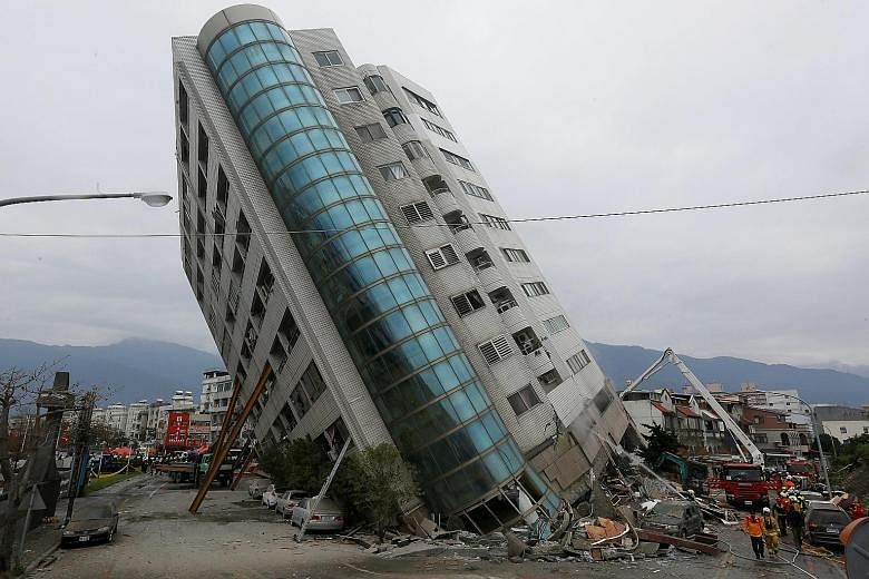 A damaged building leaning precariously and propped up by steel beams in the wake of the magnitude 6.4 quake that hit Taiwan's popular tourist city of Hualien late on Tuesday. About 67 people remain missing, with many believed to be trapped in the ru