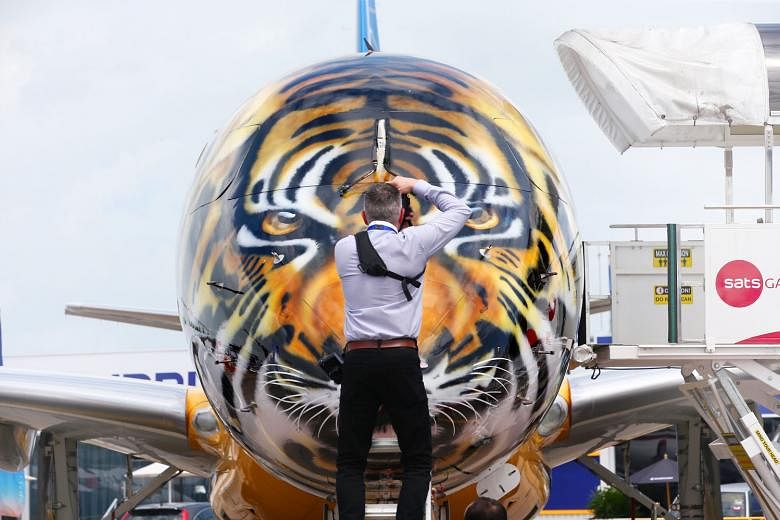 A photographer taking pictures of the tiger livery on an Embraer E190-E2. Airbus will be holding a media briefing for its A350-1000, a twin-aisle, wide-body jetliner at the Singapore Airshow. The media will also be given a tour of the A350-1000 MSN06